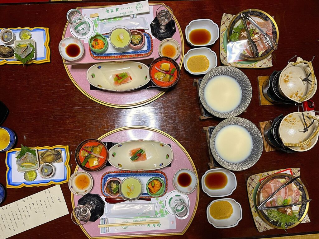 Multi-course ryokan dinner served in Japan as part of a dinner and breakfast plan.