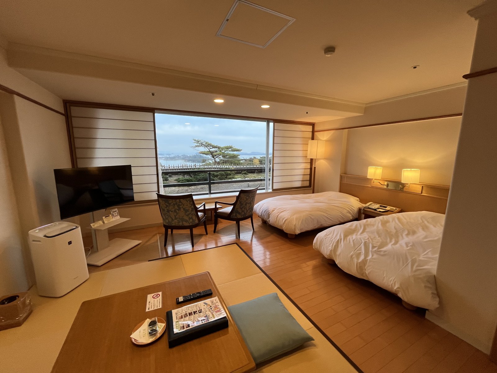 Japanese-Western hotel room with beds and tatami sitting area in Japan