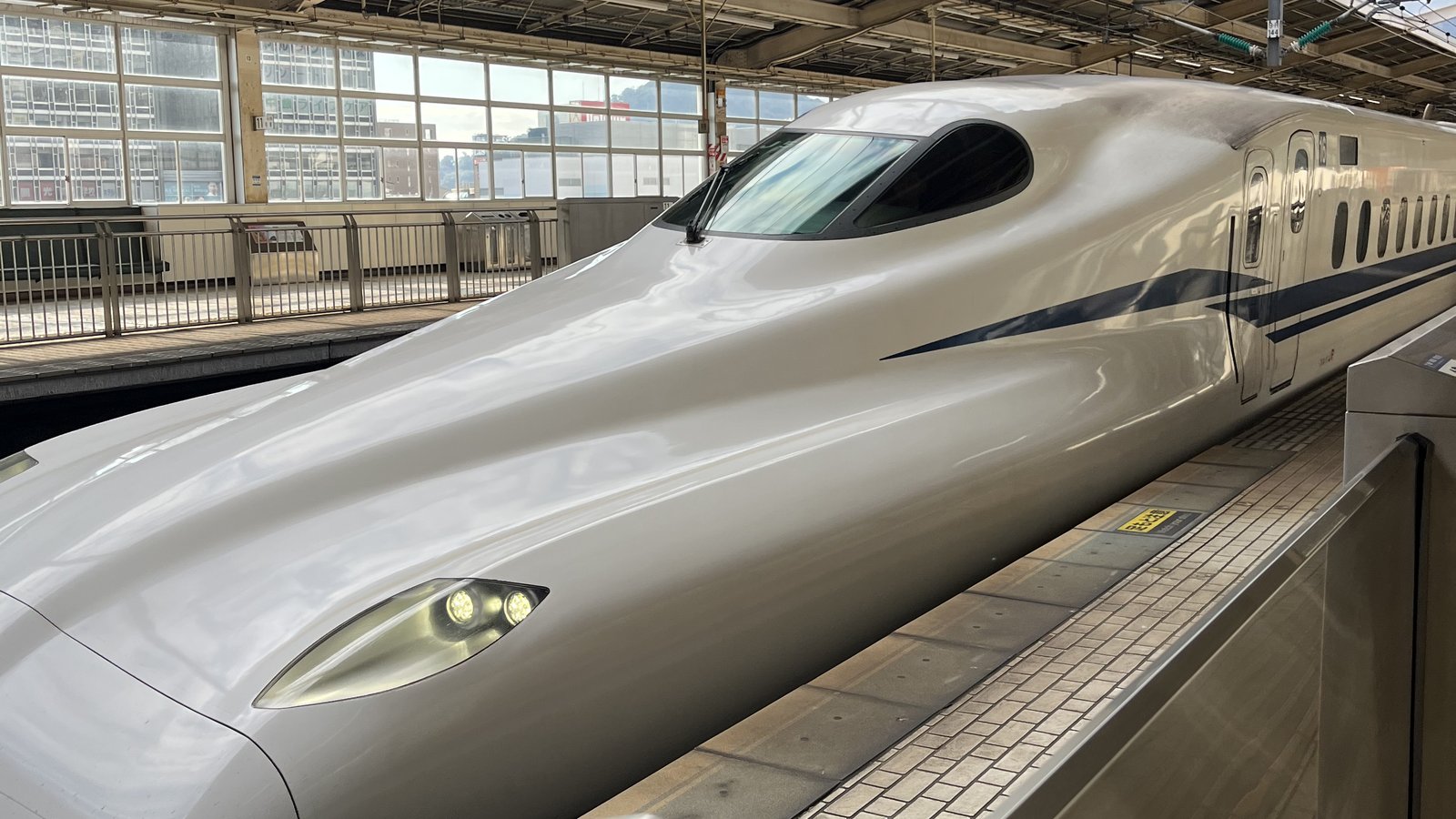 Shinkansen bullet train waiting at a station platform in Japan